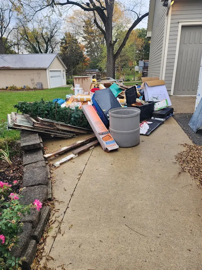 Dumpster being loaded with debris for Demolition Dumpster Rental in Winder